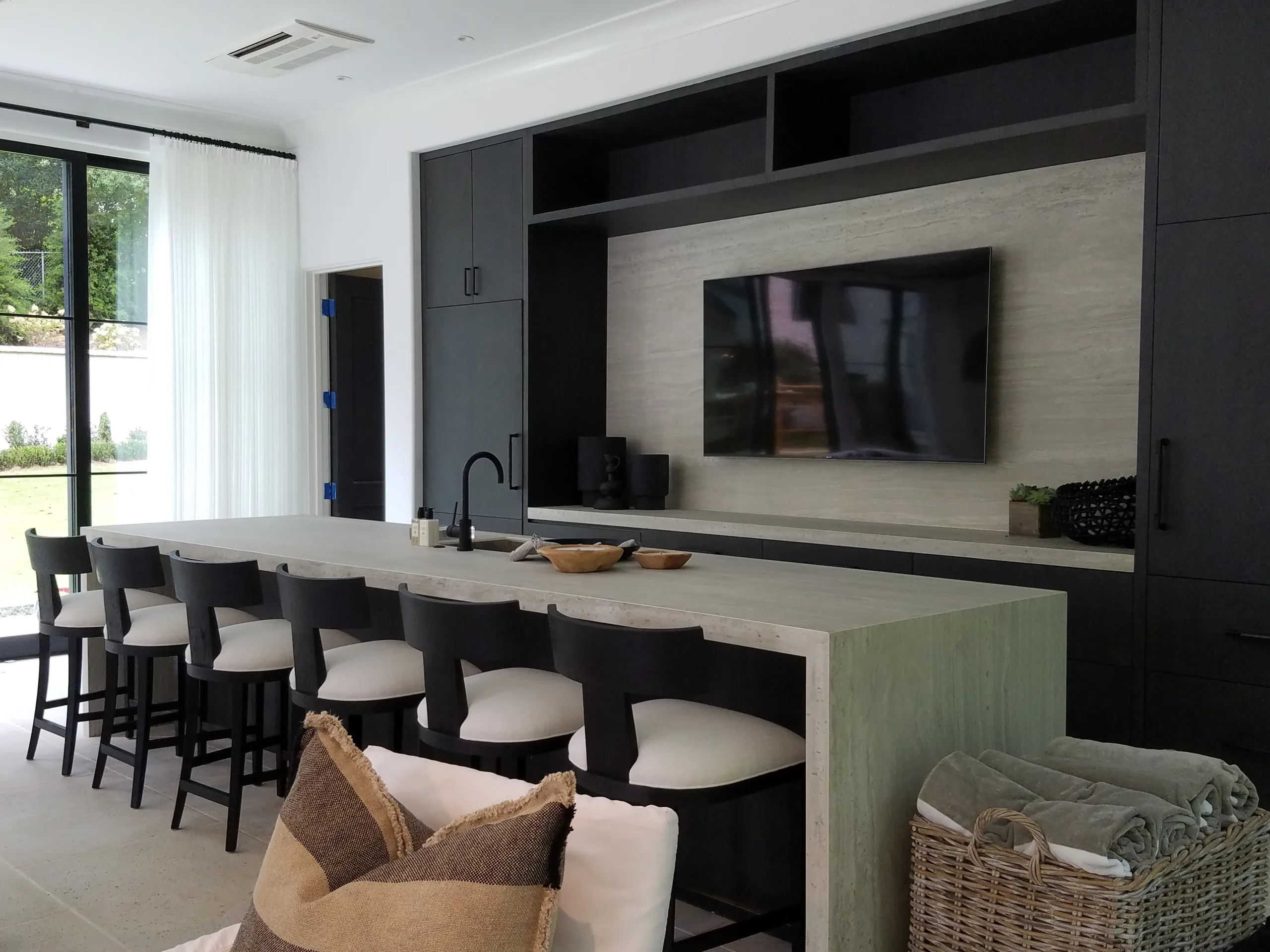 A room with a bar and a television.